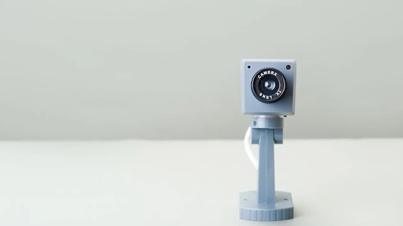 Close up on a plate of mashed potatoes, topped with baked pork chops with cream of mushroom soup, and a side of green beans.